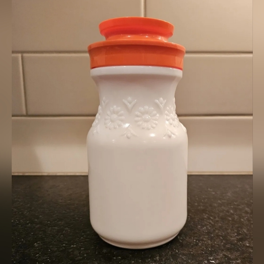 Vintage tang milk glass embossed with daisies with orange lid